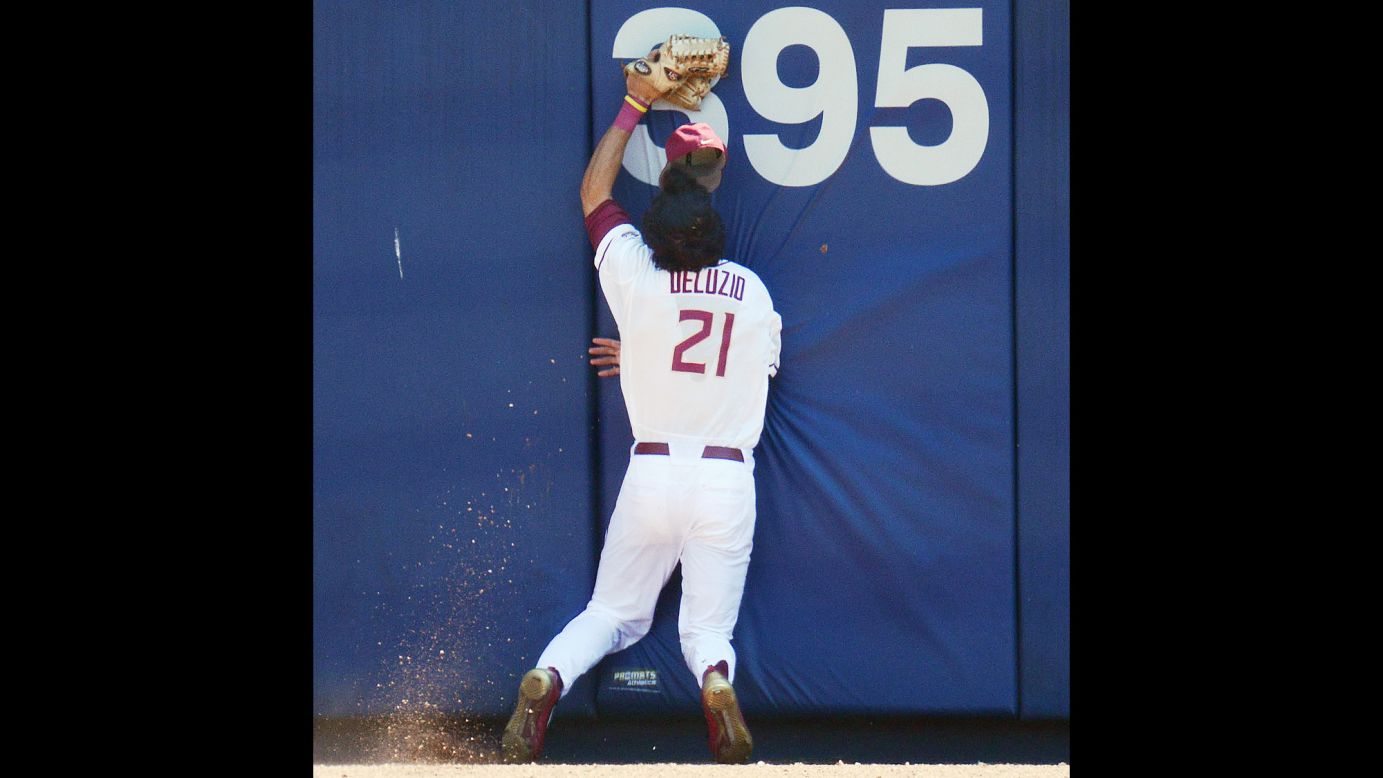 Florida State outfielder Ben DeLuzio runs into the center-field wall after making a catch in the ACC tournament on Wednesday, May 25. His face was cut on the play, but he stayed in the game as the Seminoles defeated North Carolina State 7-3.