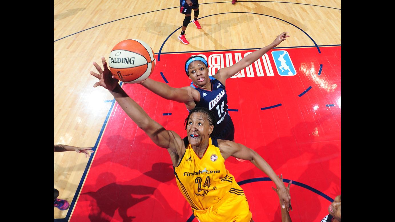 Indiana's Tamika Catchings, front, and Atlanta's Rachel Hollivay reach for a rebound during a WNBA game in Atlanta on Sunday, May 29.