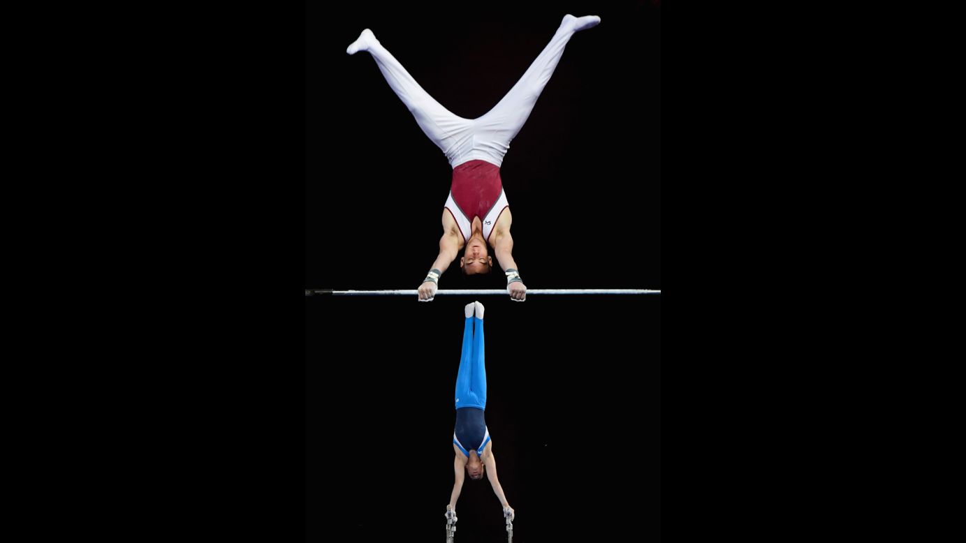Kurt Grumelart, foreground, competes on the high bar as Alexander Waro competes on the parallel bars at the Australian Gymnastics Championships on Tuesday, May 24.