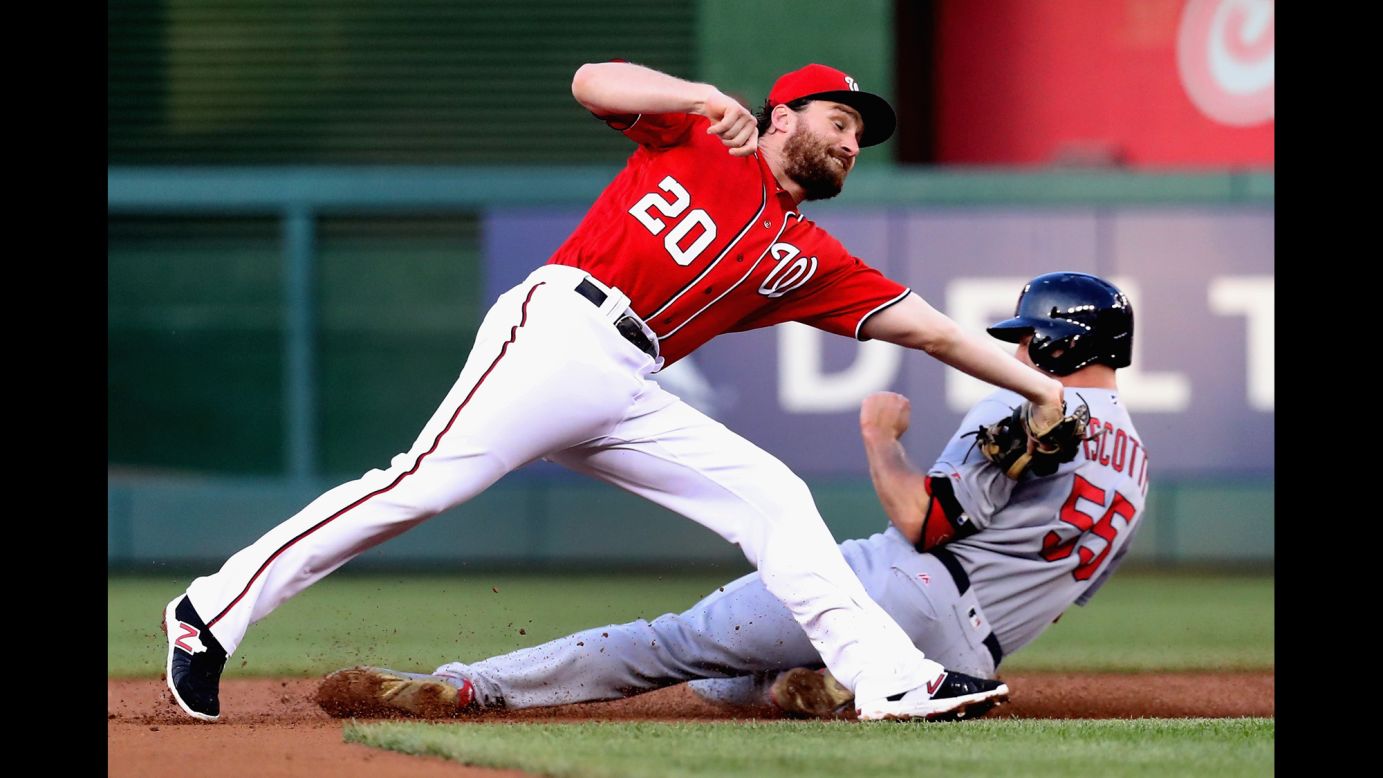 St. Louis' Stephen Piscotty steals second base, avoiding the tag of Washington's Daniel Murphy on Saturday, May 28.