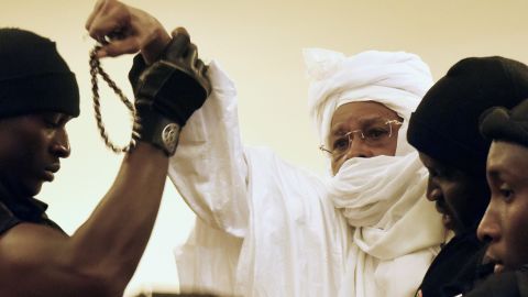 Prison guards escort ex-Chadian dictator Hissene Habre into court when his trial first began in July in Dakar, Senegal. 