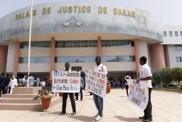 Activists stand outside the courthouse in Dakar before Monday's verdict.  