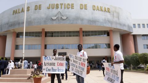 Activists stand outside the courthouse in Dakar before Monday's verdict.  