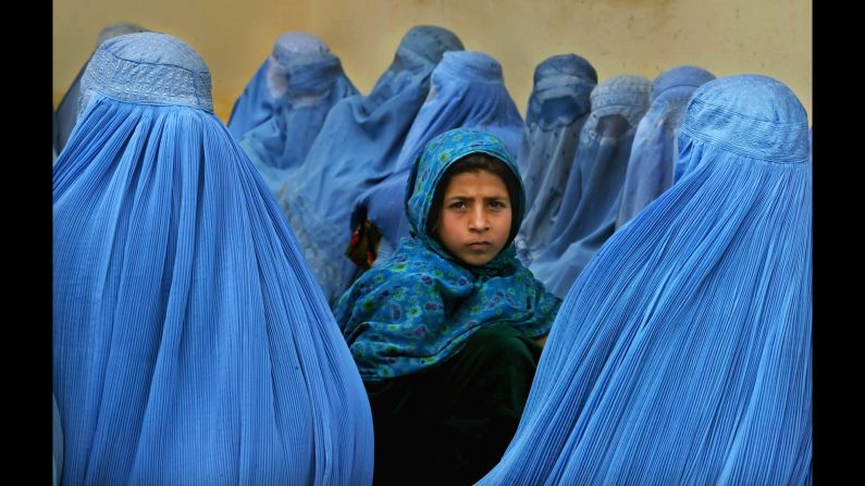 Women wait in line to be treated at a health clinic in Kalakan, Afghanistan, in February 2003.