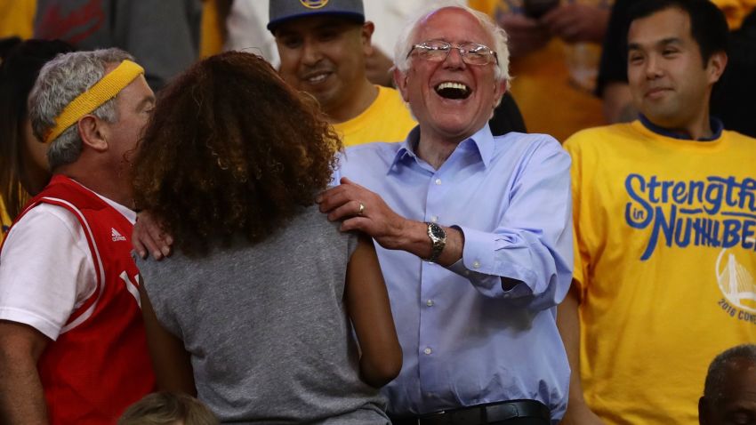 OAKLAND, CA - MAY 30:  Democratic presidential candidate Bernie Sanders greets fans at Game Seven of the Western Conference Finals between the Golden State Warriors and the Oklahoma City Thunder during the 2016 NBA Playoffs at ORACLE Arena on May 30, 2016 in Oakland, California. NOTE TO USER: User expressly acknowledges and agrees that, by downloading and or using this photograph, User is consenting to the terms and conditions of the Getty Images License Agreement.  (Photo by Ezra Shaw/Getty Images)