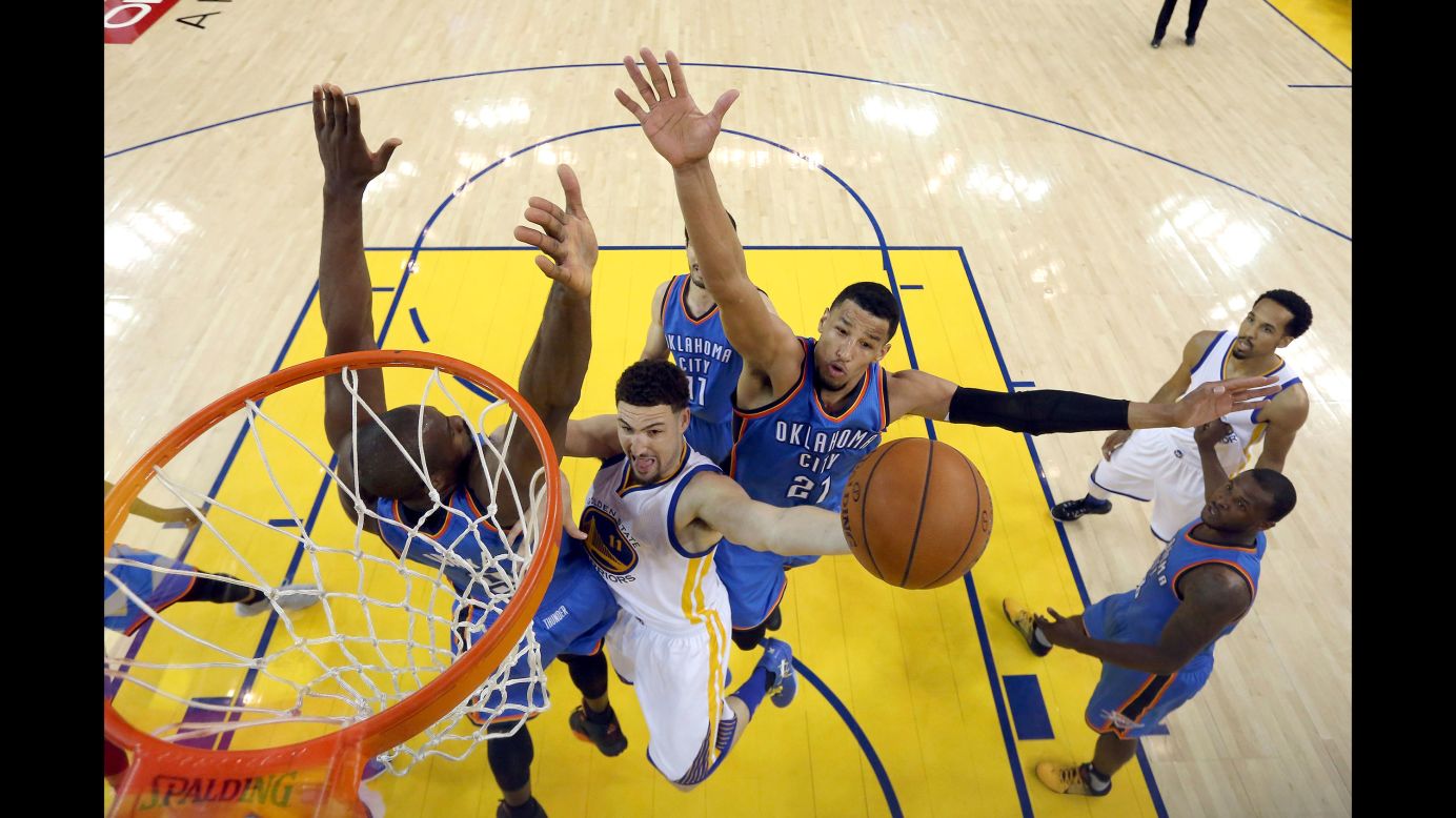 Golden State's Klay Thompson shoots between Oklahoma City's Serge Ibaka, left, and Andre Roberson during Game 7 of the NBA's Western Conference Finals on Monday, May 30. The Warriors won 96-88, overcoming a 3-1 series deficit, and they will advance to the NBA Finals for a rematch with the Cleveland Cavaliers. The Warriors defeated Cleveland last year for the NBA title.