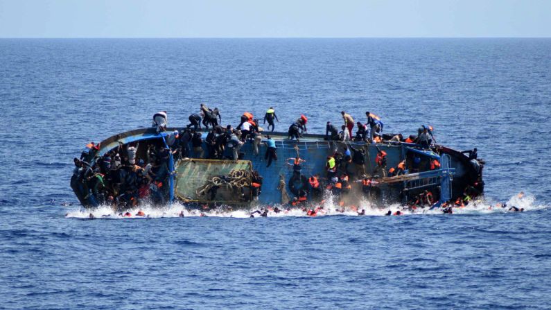 A ship crowded with migrants <a href="index.php?page=&url=http%3A%2F%2Fwww.cnn.com%2F2016%2F05%2F25%2Fmiddleeast%2Fmigrant-ship-overturns%2F" target="_blank">flips onto its side</a> in May 2016 as an Italian navy ship approaches off the coast of Libya. Passengers had rushed to the port side, a shift in weight that proved too much. Five people died and more than 500 were rescued.