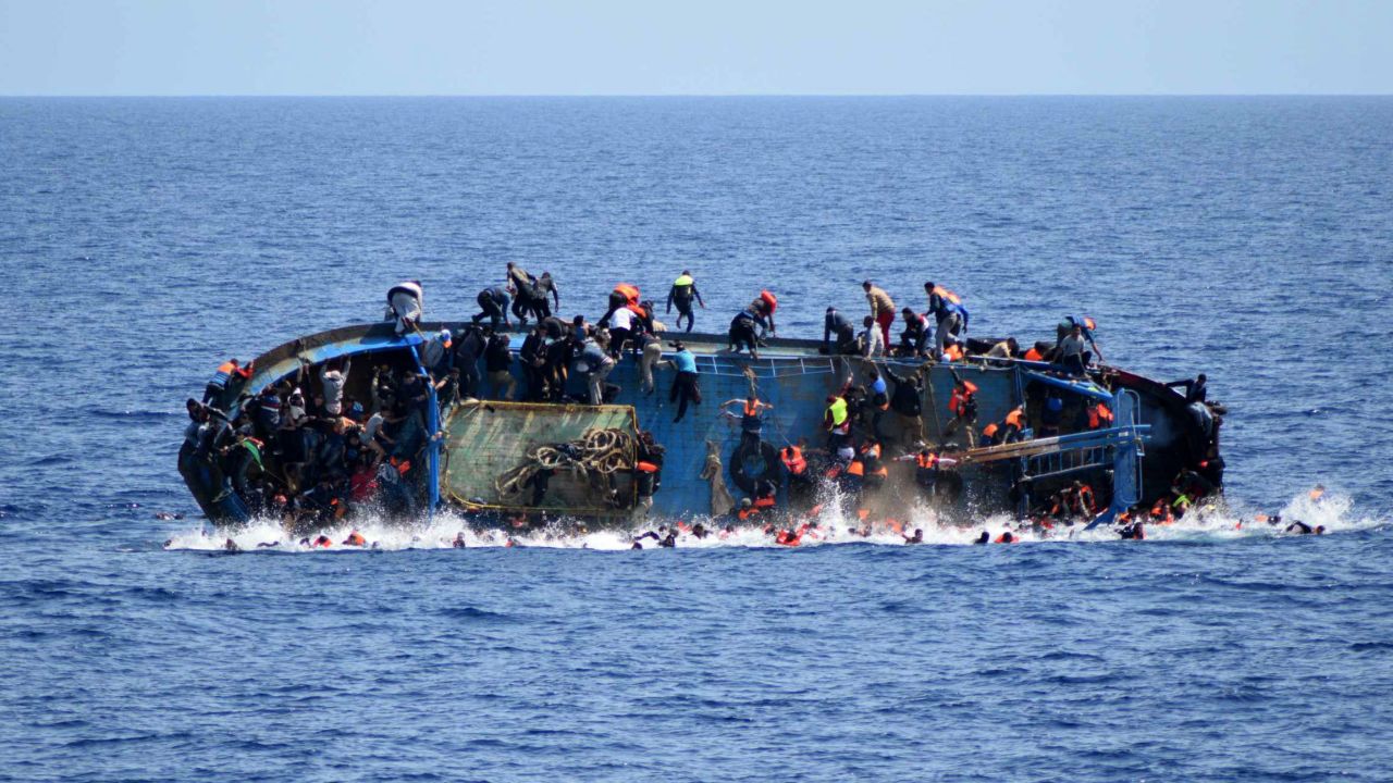 A ship crowded with migrants <a href="http://www.cnn.com/2016/05/25/middleeast/migrant-ship-overturns/" target="_blank">flips onto its side</a> in May 2016 as an Italian navy ship approaches off the coast of Libya. Passengers had rushed to the port side, a shift in weight that proved too much. Five people died and more than 500 were rescued.