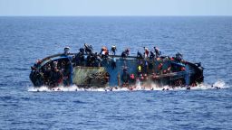 Migrants jump ship before their boat overturns off the Libyan coast on Wednesday, May 25.