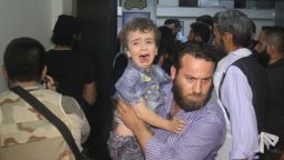 A man carries a crying child at a hospital following Russian air strikes that targeted many areas in Syria's northwestern city of Idlib early on May 31, 2016, according to the Syrian Observatory of Human Rights.