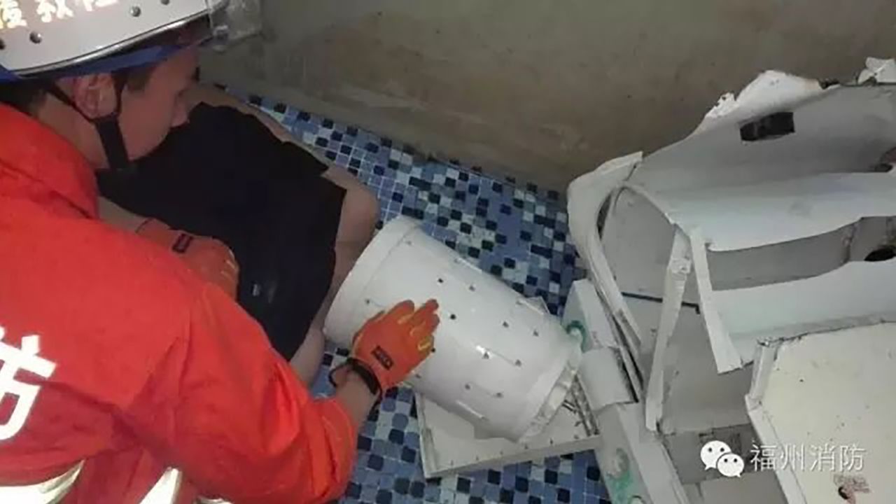 The firefighers separated the drum from the washing machine to free the man.