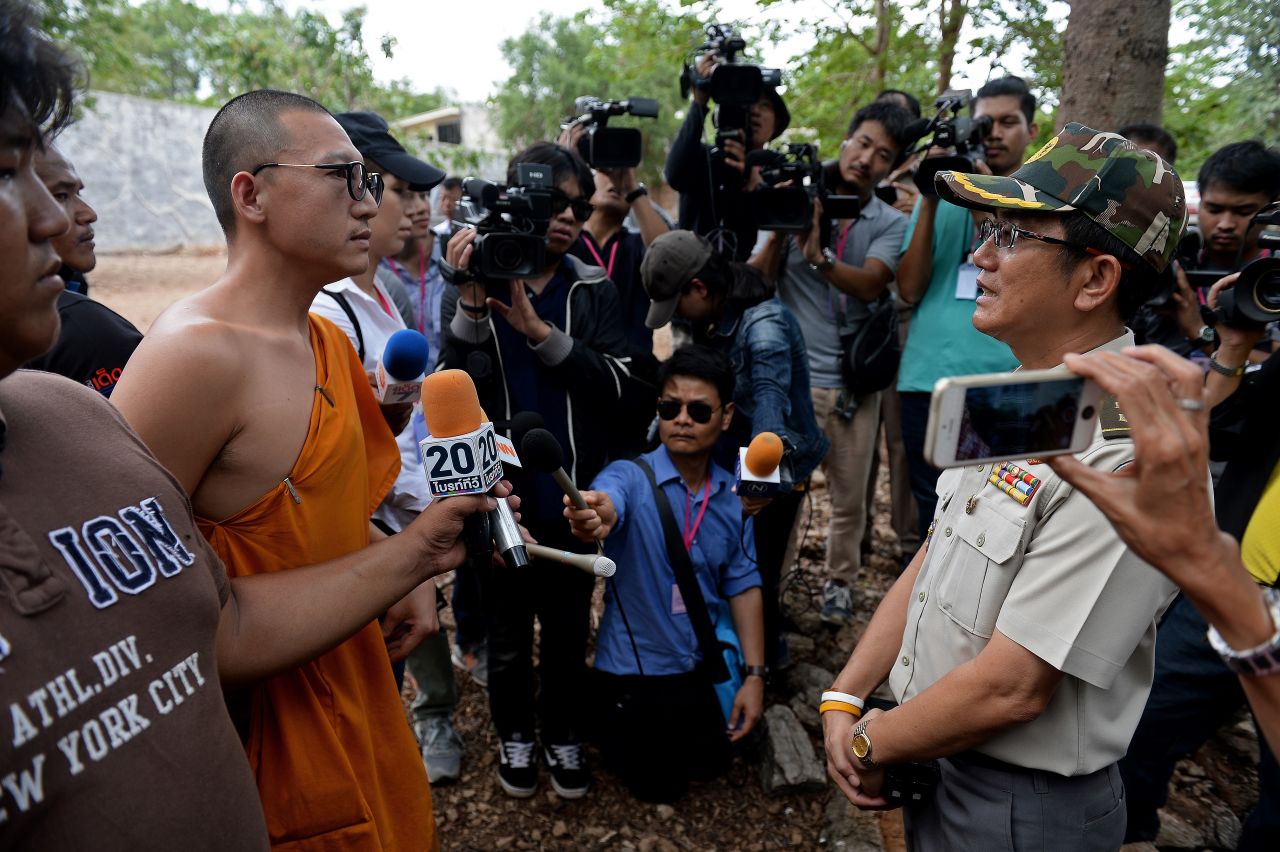 A Thai wildlife official speaks with a monk at the temple.  