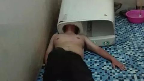 A man in southeast China's Fujian province got his head stuck inside a washing machine while trying to fix the tub on Sunday, May 29, 2016. 