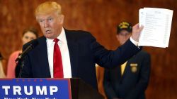 Republican presidential candidate Donald Trump holds a sheet of paper with his donations listed at a news conference at Trump Tower where he addressed issues about the money he pledged to donate to veterans groups following a skipped a debate in January before the Iowa caucuses on May 31, 2016 in New York City. 