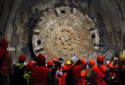 A giant drilling machine completes the tunnel beneath the Swiss Alps during a ceremony in October 2010.