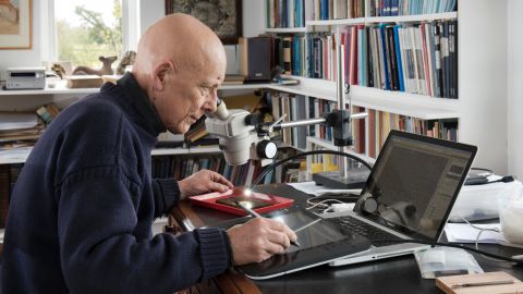 Dr Roger Tomlin deciphers a writing tablet.