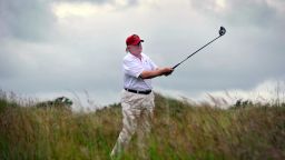 US tycoon Donald Trump plays a stroke as he officially opens his new multi-million pound Trump International Golf Links course in Aberdeenshire, Scotland, on July 10, 2012. Work on the course began in July 2010, four years after the plans were originally submitted. 