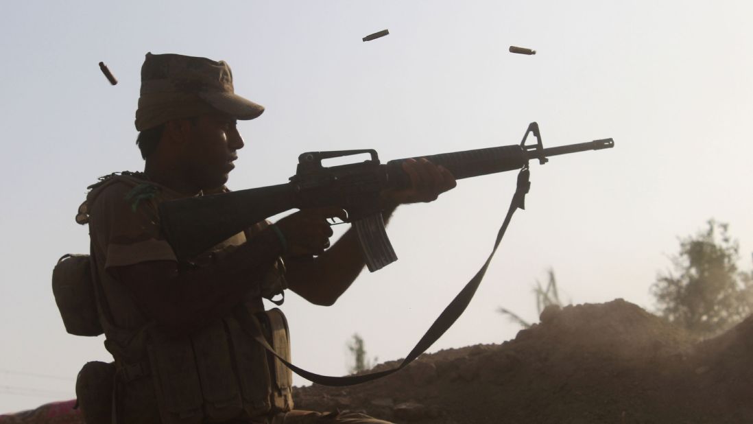 A member of pro-government forces fires at a front line in the Albu Huwa area south of Falluja on June 1.