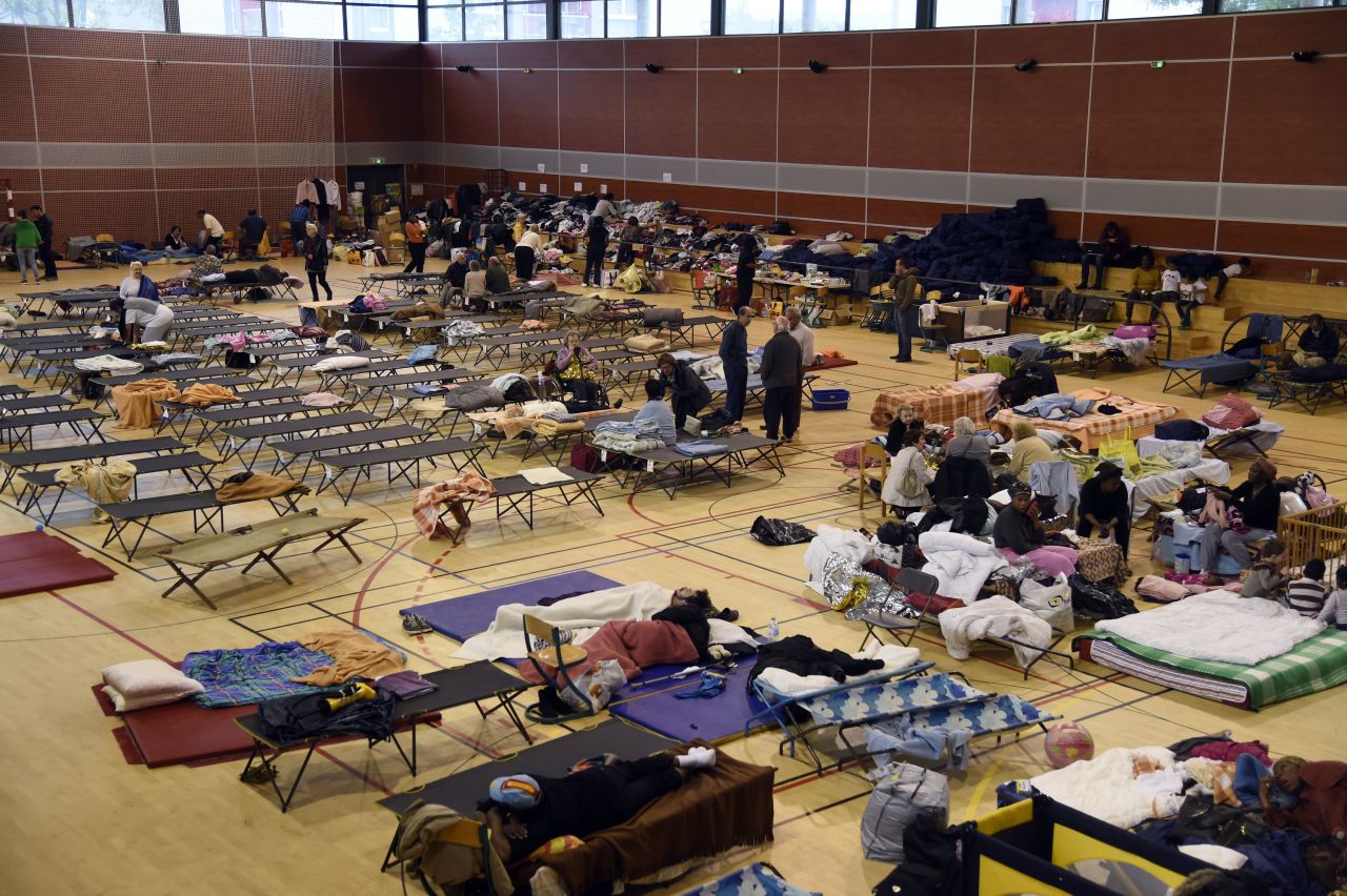 People wait in a Nemours gymnasium after evacuations.