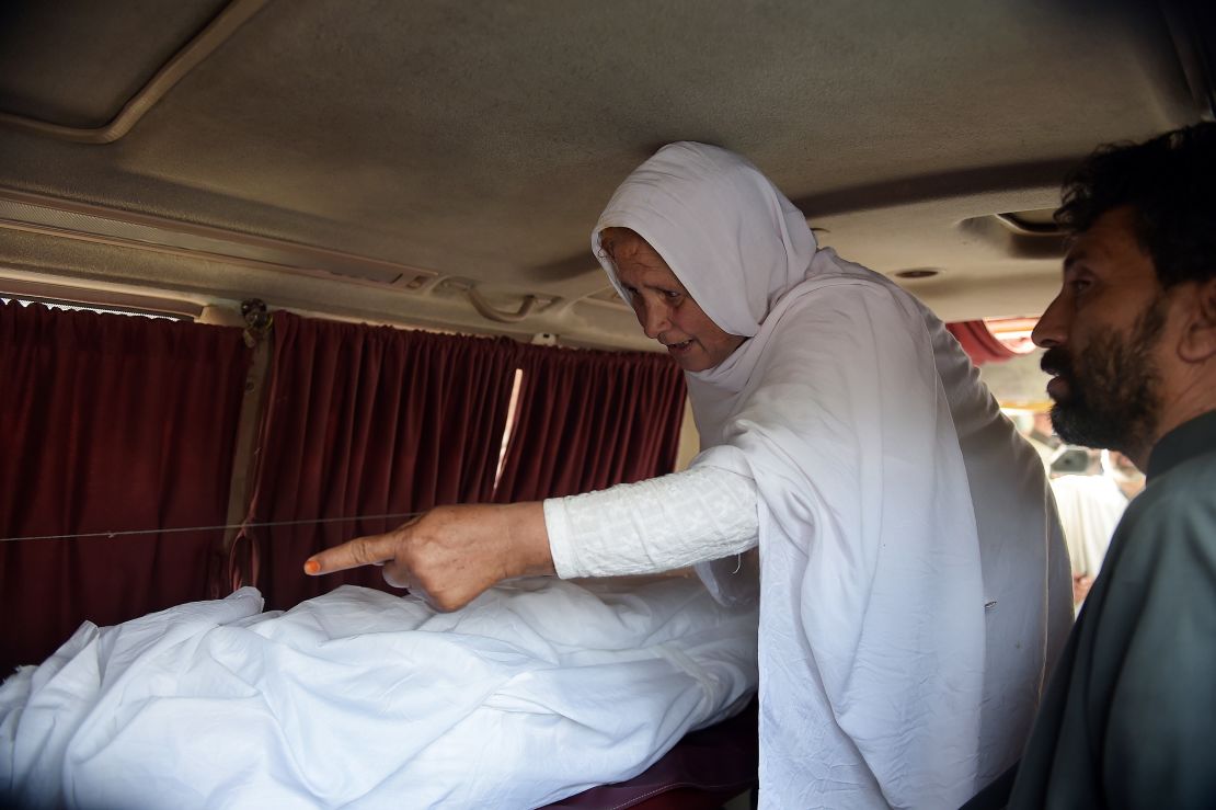 Maria's grandmother mourns next to her body in an ambulance outside a hospital in Islamabad.