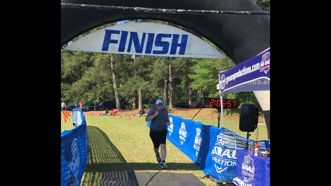 "Crossing the finish line at the Tall Pines Sprint Triathlon, some 100 pounds lighter than six months before."