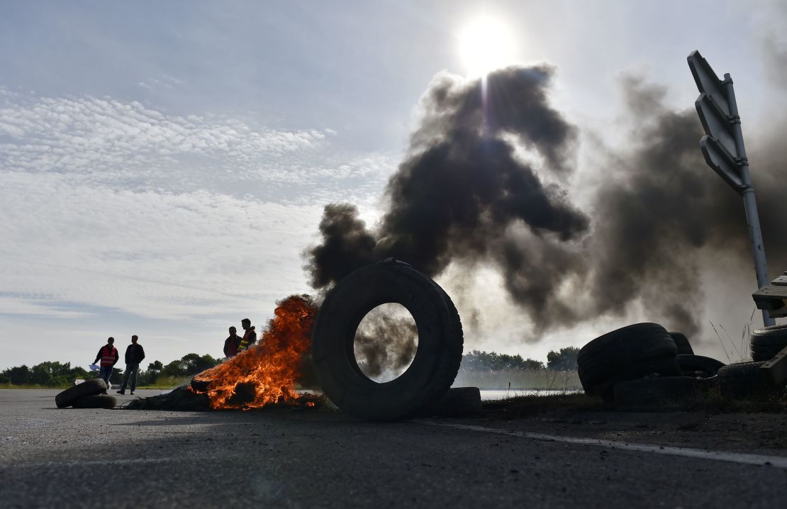 Union members stand next to tires set ablaze near an oil refinery this week in Donges. 