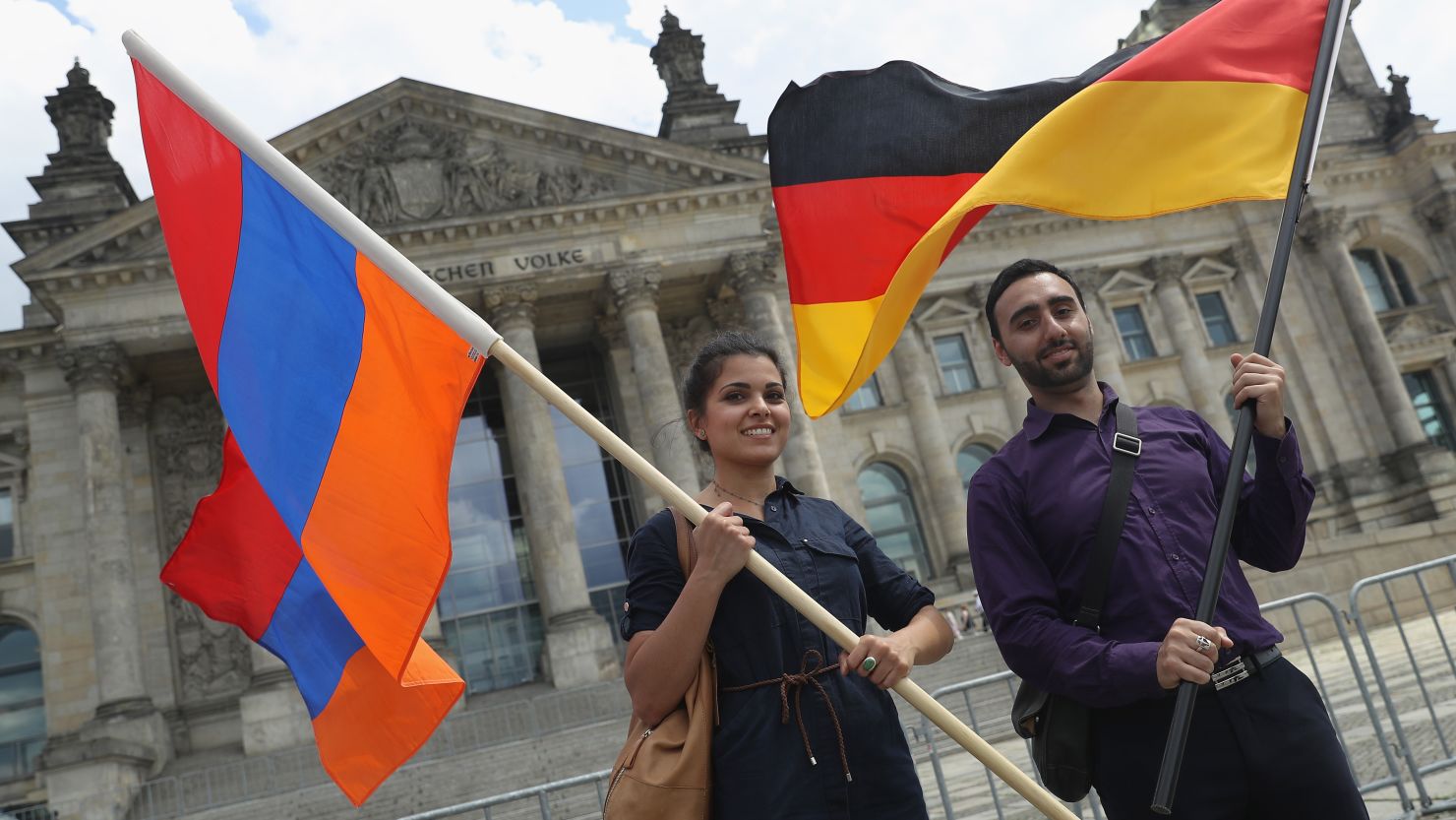 Activists hold up Armenian and German flags outside the Reichstag after a resolution recognizing the 1915 Armenian genocide.