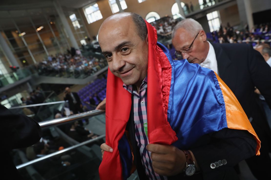 A visitor wars the Armenian flag during the parliament vote. 