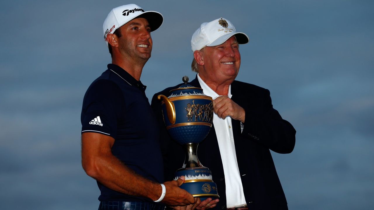 Winner Dustin Johnson and course owner Donald Trump pose with the Gene Sarazen Cup after Johnson's 29015 win at the World Golf Championships-Cadillac Championship at Trump National Doral on March 8, 2015. The event will be relocated from 2017.