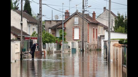 A man maneuvers through a flooded street in Nemours, south of Paris, on June 3.