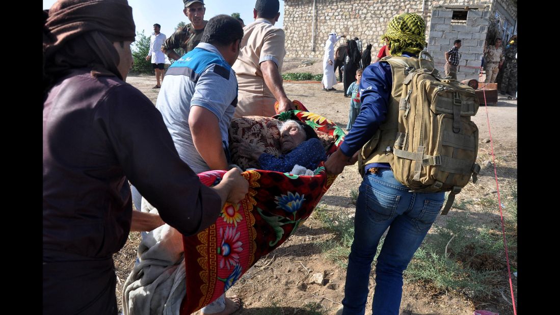 Internally displaced civilians flee their homes after crossing the Euphrates River outside Falluja on Thursday, June 2.