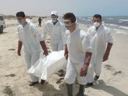 Volunteers carry bodies for burial after they washed ashore this week in Libya.