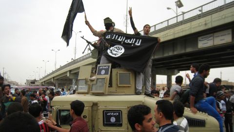 Islamic State fighters celebrate after commandeering a vehicle in Falluja. The city fell to ISIS in 2014.