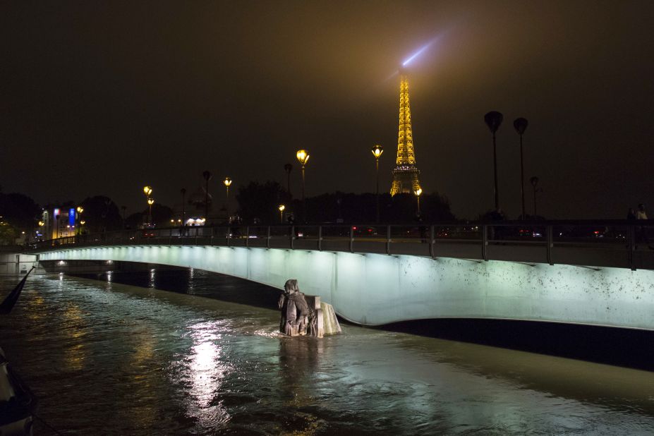 The Zouave statue at Pont de l'Alma, which serves as a measuring instrument for water levels, is partly submerged by the Seine on Friday, June 3.