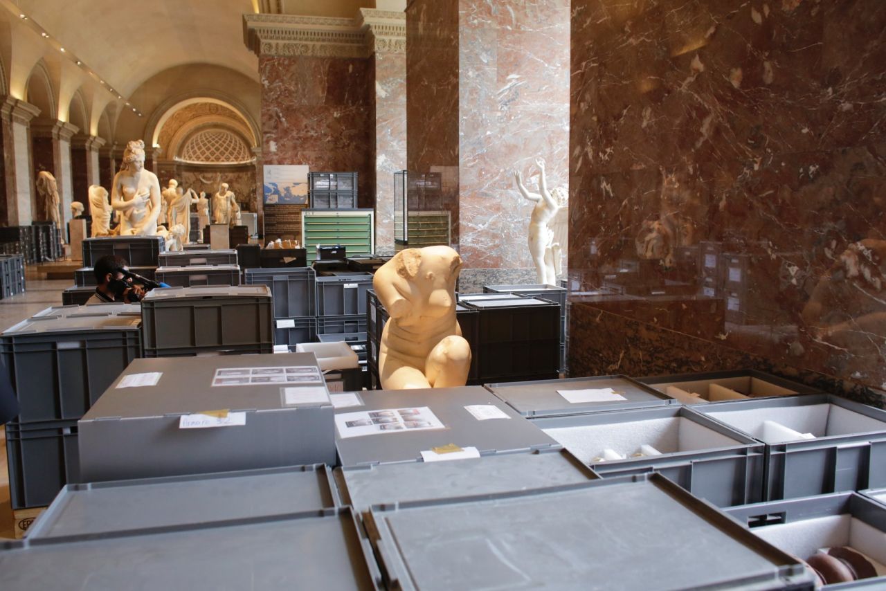 Plastic boxes containing artworks are placed between sculptures for safe-keeping in an exhibition hall at the Musée du Louvre on June 3. 