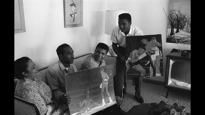 The family displays Cassius Sr.'s paintings in the living room of Ali's Louisville home in 1963.