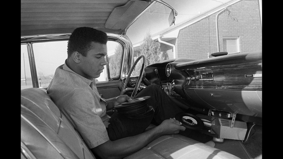 Cassius Clay plays a record in his 1960 Cadillac outside of his home in 1960.