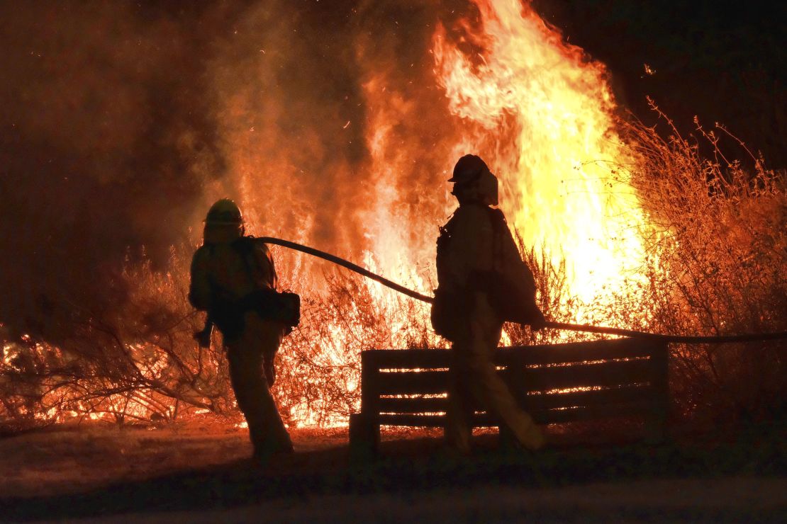 Firefighters battle the blaze near Calabasas on Saturday.