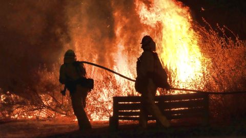 Firefighters battle the blaze near Calabasas on Saturday.