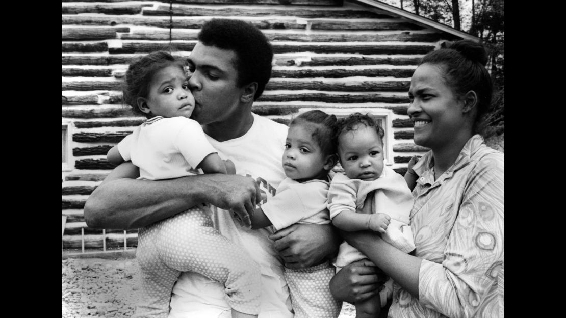 Ali stands with his wife and children outside his training camp in Deer Lake, Pennsylvania.
