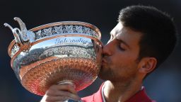 Serbia's Novak Djokovic kisses his trophy after winning the men's final match against Britain's Andy Murray at the Roland Garros 2016 French Tennis Open in Paris on June 5, 2016. / AFP / MARTIN BUREAU        (Photo credit should read MARTIN BUREAU/AFP/Getty Images)