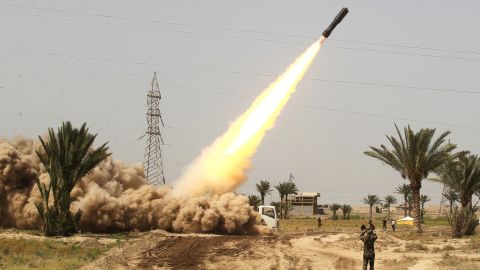 Pro-government forces and Shiite militia fighters fire rockets toward ISIS fighters in Falluja on Saturday, June 4.