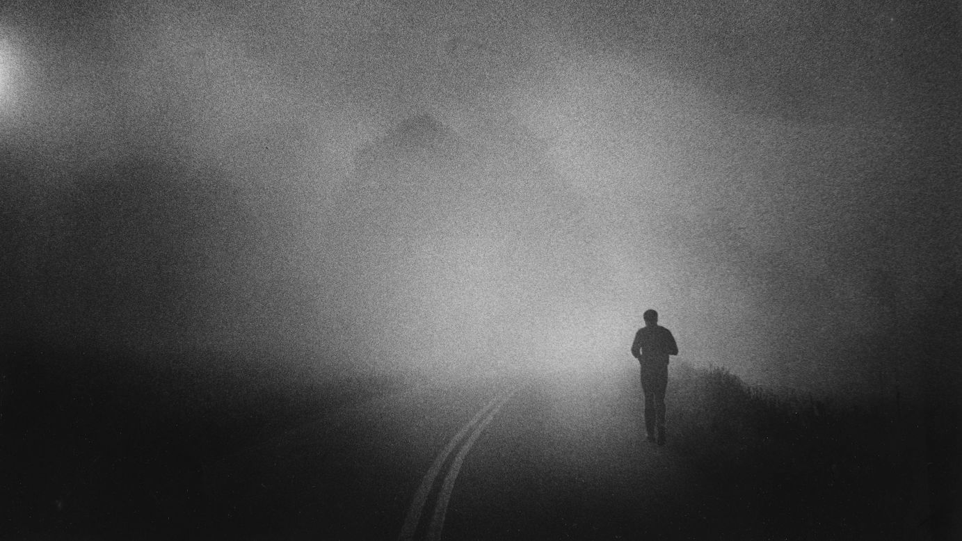 Ali takes his daily run along a Pennsylvania country road, shrouded in early morning fog, in 1978.