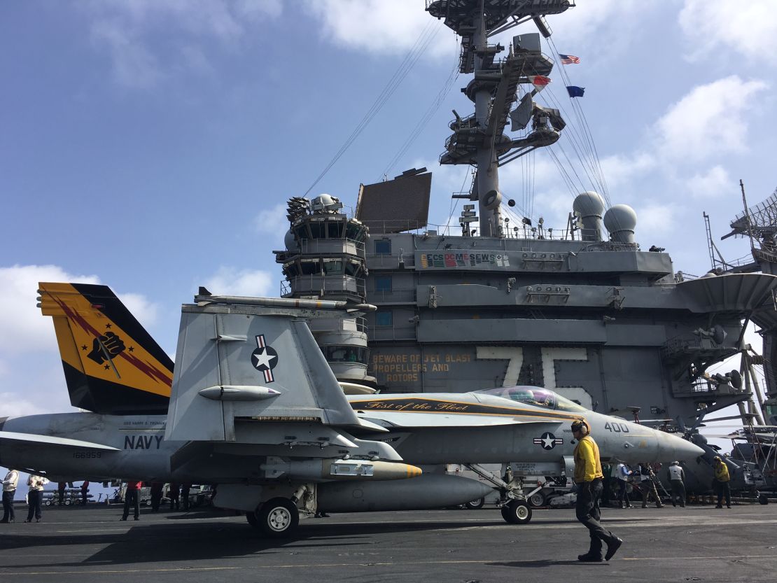 An F18 Hornet locked into the steam catapult shortly before being launched off the USS Harry Truman carrier