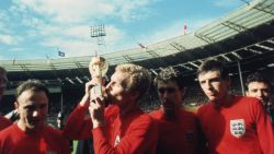 England captain Bobby Moore kissing the Jules Rimet trophy as the team celebrate winning the 1966 World Cup final against Germany at Wembley Stadium. His team mates are, left to right, George Cohen, Geoff Hurst and Martin Peters, 30th July 1966. (Photo by Hulton Archive/Getty Images)