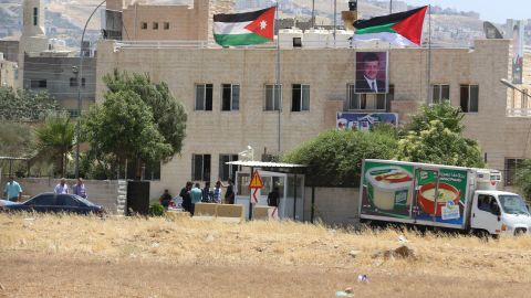 Security personnel are outside a Jordanian intelligence agency office in the Baqaa refugee camp following Monday's attack.