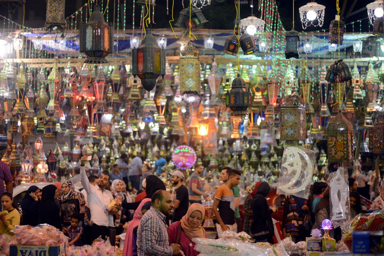 Egyptians walk past traditional lanterns in the Saida Zeinab district of Cairo on Sunday, May 29.