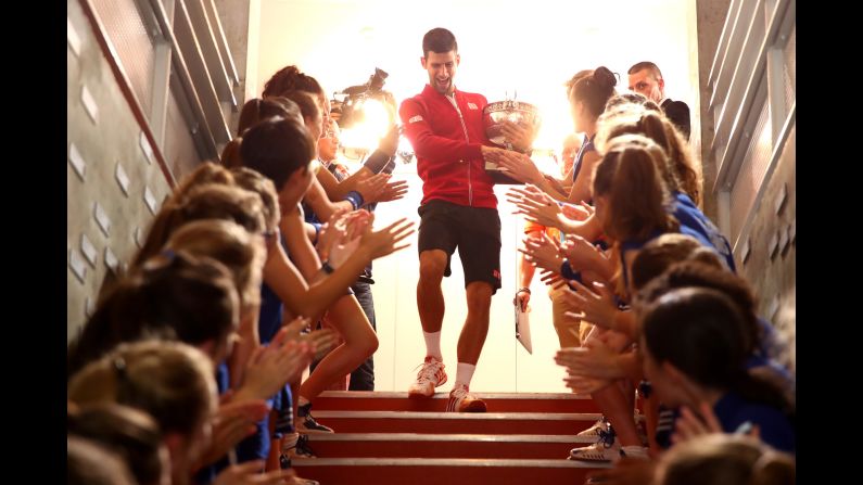 Novak Djokovic celebrates <a href="index.php?page=&url=http%3A%2F%2Fwww.cnn.com%2F2016%2F06%2F06%2Ftennis%2Fnovak-djokovic-french-open-roland-garros-history%2Findex.html" target="_blank">his French Open title</a> with the tournament's ball girls on Sunday, June 5. By defeating Andy Murray, Djokovic completed the career Grand Slam. He is also the first man since Rod Laver in 1969 to hold all four Grand Slam titles at once.