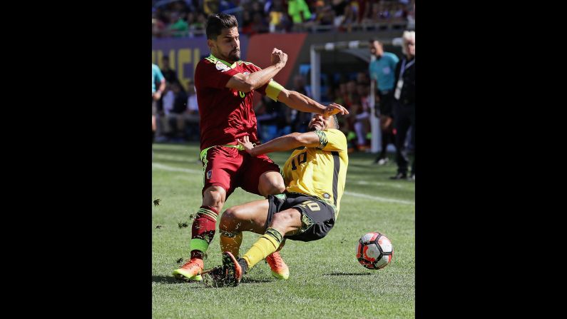 Venezuela's Tomas Rincon, left, collides with Jamaica's Jobi McAnuff during a Copa America match in Chicago on Sunday, June 5. Venezuela won the match 1-0.