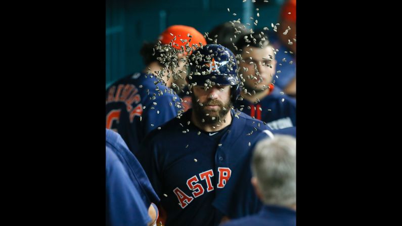 Houston's Evan Gattis receives a face full of sunflower seeds after hitting a home run against Oakland on Sunday, June 5.
